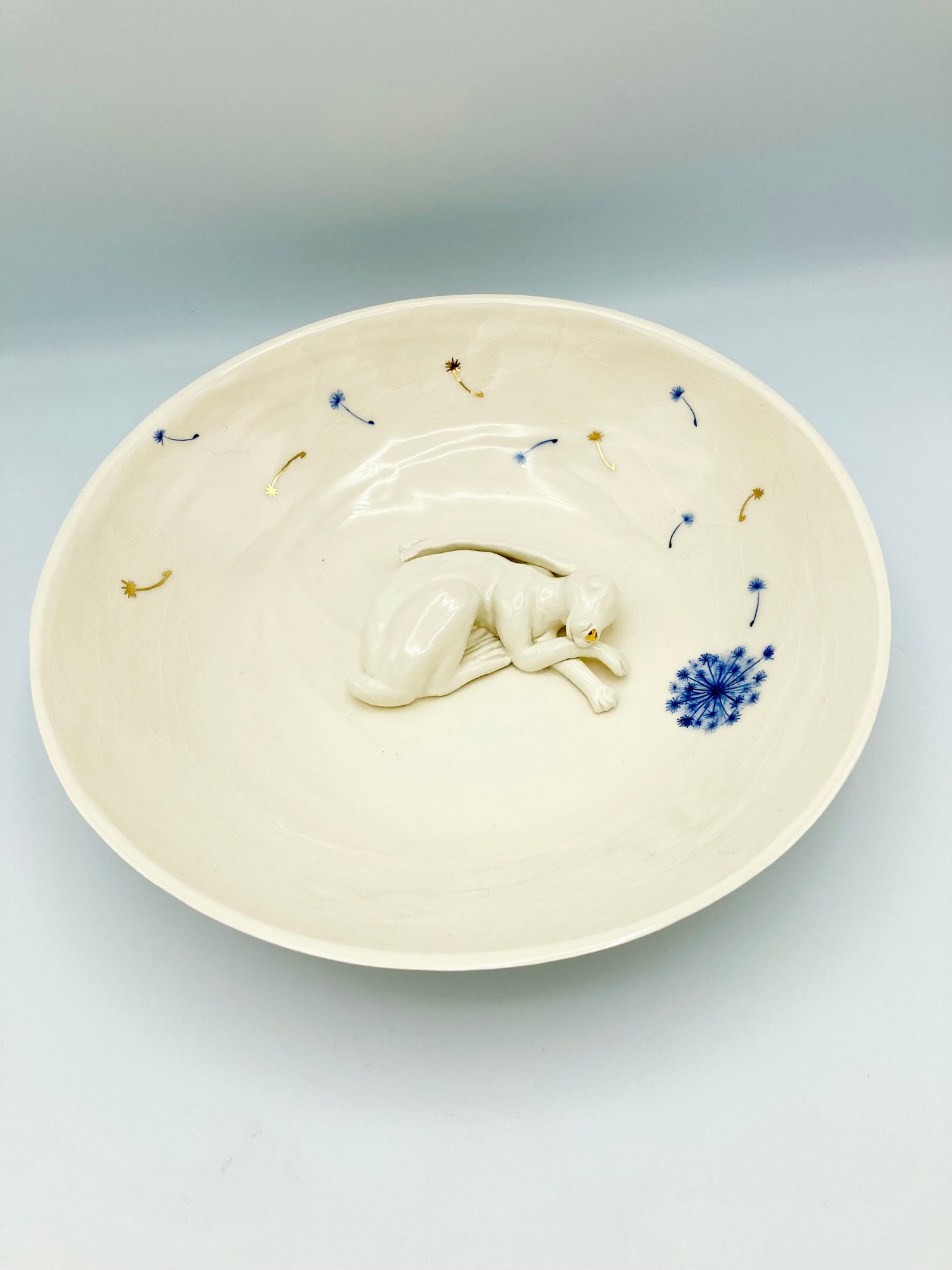Large sleeping hare bowl with blue and gold dandelions